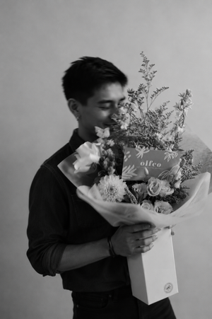 Person holding an anniversary flower bouquet with seasonal blooms in Vancouver