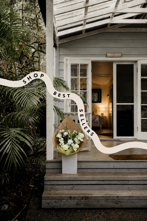 Decorative sign with flowers delivered on a porch of a beach house in Vancouver