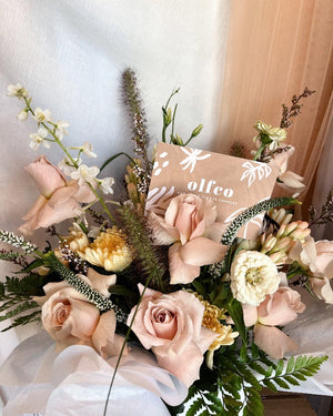Beautiful vase flower arrangement in soft pink pastels with roses